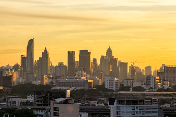 Fototapeta premium Aerial view modern office buildings in Bangkok city downtown with sunrise time