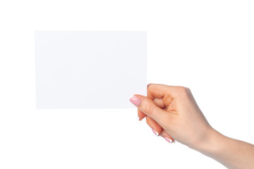 Obraz premium Woman's hand holding blank white sheet of paper isolated on white