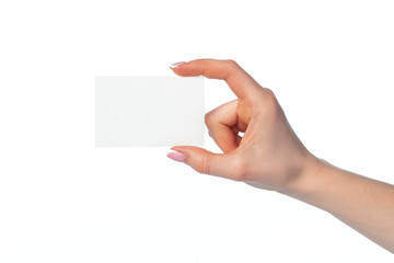 Obraz premium Female hand with blank white business card isolated on white