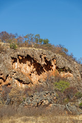 Wave like forms of ancient lava flows form an impressive Rock structure on a game Reserve in the plains of South Africa.