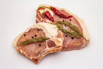 Raw pork steaks isolated on white background