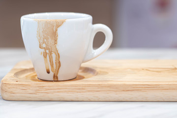 Dirty coffee white mug and Coffee mug stain on wooden plate.