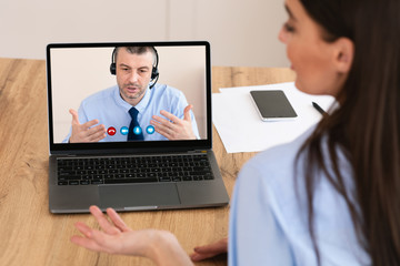 Workers having discussion during video call at home
