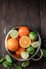 Citrus fruits - orange, lime, lemon on wooden background