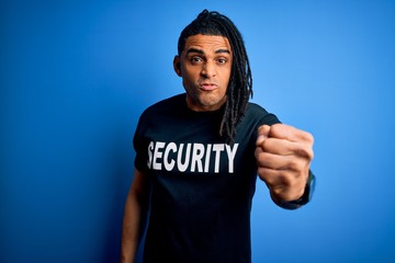Young african american afro safeguard man with dreadlocks wearing security uniform annoyed and...