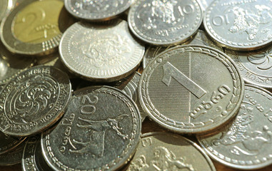 Closeup of Georgian 1 Lari and 20 Tetri Coins on Another Coin Pile