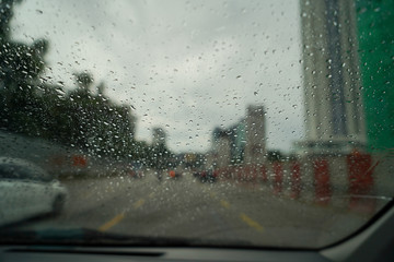 The window of the car during a rainy day