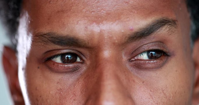 Person thinking about solution, african man brainstorming ideas, looking for answers, close-up of eyes