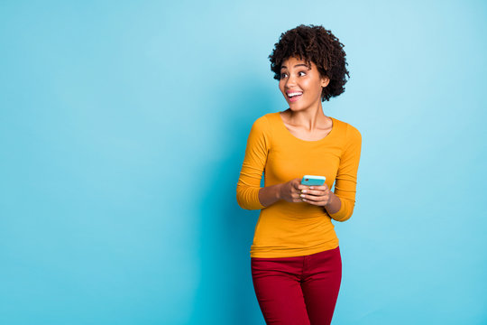 Portrait of her she nice attractive lovely glad excited amazed cheerful cheery wavy-haired girl using cell positive reaction share media isolated over bright vivid shine vibrant blue color background