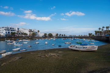 Fototapeta na wymiar Fisher boats at the laguna Charco de San Gines at sunset, city of Arrecife, Lanzarote, Canary Islands. October 2019