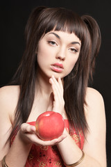 Portrait of beautiful young woman with apple