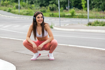 young beautiful woman jogging, fitness outfit, listening to music on headphones, smartphone, skinny perfect slim body, healthy living lifestyle, summer, smiling, happy
