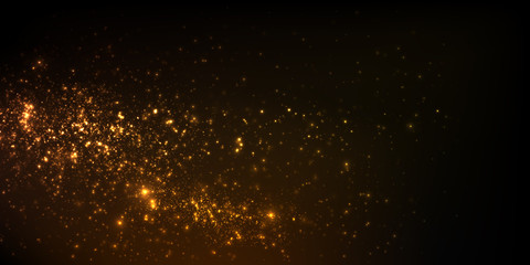 Sparkling golden particles on black background	