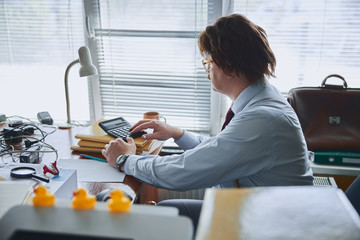 Retro style businessman in his office without computer