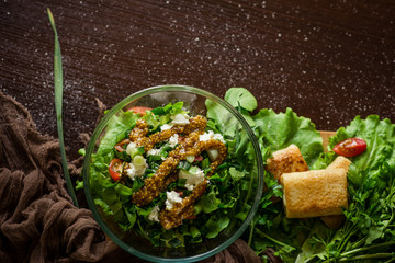 
Salad with fresh vegetables and pancakes. Top view.