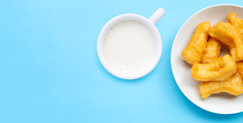 Deep-fried dough stick and Soybean milk on blue background.