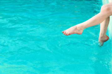 Detail of girl on the edge at pool
