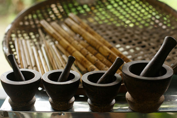 Stone mortars with pestle for grinding spices and seasonings. Dishes and cooking tools