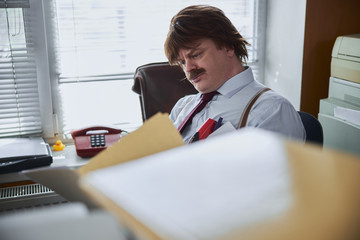 Professional realtor frowning while working with documents
