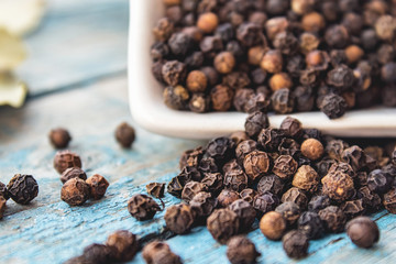 The black pepper is scattered on blue boards.