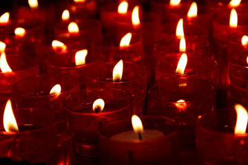 Red church candles lit as a prayer
