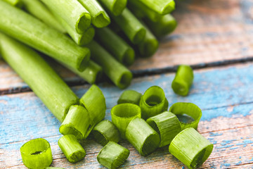 Fresh green onion sliced in rings and lies on the table.
