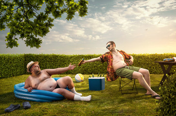 Two funny nerds relaxing in the backyard on the summer day - obrazy, fototapety, plakaty