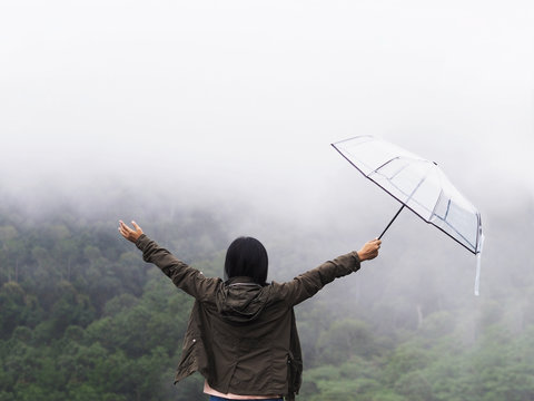 Back View Happy Woman Tourist Hold Umbrella Over Green Rain Forest Background.