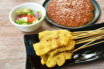 pork satay dipping with sweet peanut sauce and pickled vegetable cup