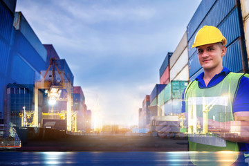 Fototapeta na wymiar Double exposure, Caucasian man engineer using digital tablet and wearing yellow safety helmet and check for control loading containers box from Cargo freight ship for import and export, transport.