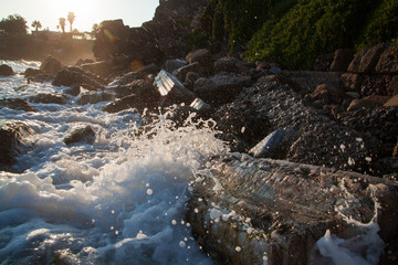 Splashes and waves in the evening light, fragments of ancient ruins