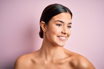 Close up of young beautiful woman with clear and pure skin. Perfect and clean skincare wearing natural makeup. Smiling happy looking fresh and healthy.