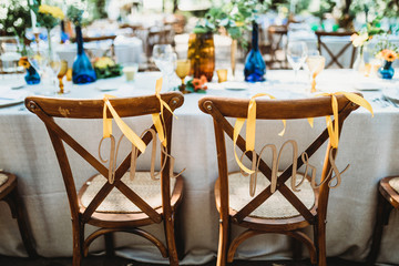 Mr and Mrs sign on chairs at wedding 