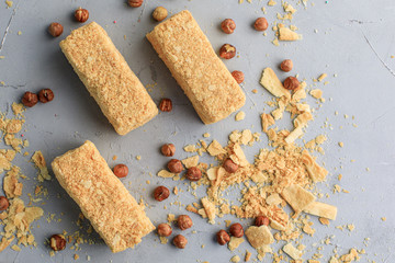 3 small napoleon cakes on a gray background with nuts