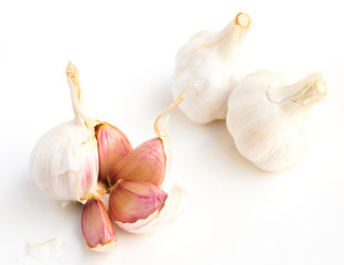 garlic heads and cloves on white background