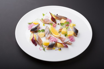 Salted herring fillet slices served with onion
