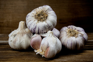 purple garlic on wooden foreground