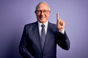 Grey haired senior business man wearing glasses and elegant suit and tie over purple background...