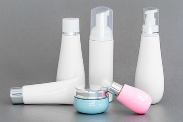 blank bottle packaging with natural cosmetic cream, serum, skincare, lotion, tonic. bio organic product on gray background. spa concept. Cosmetic design template. Plastic bottle label design