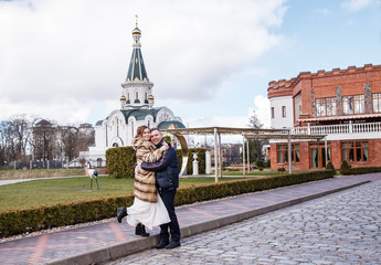 newlywed couple on a walk in the park