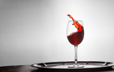 red wine spills out of a glass