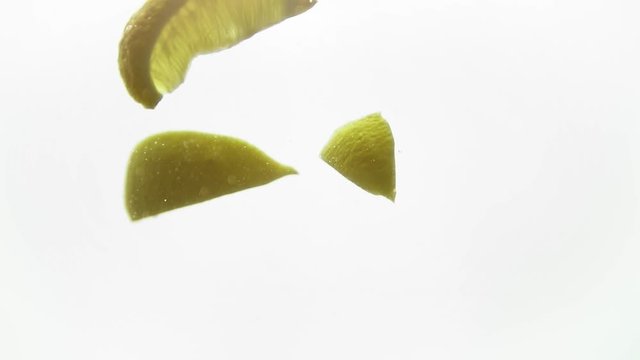 Bright parts of lemon under water. Tasty and healthy food