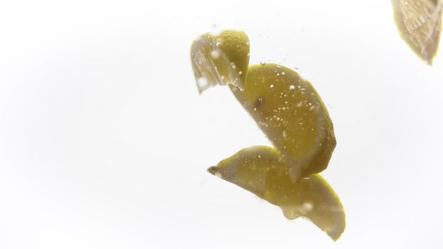 Bright parts of lemon under water. Tasty and healthy food