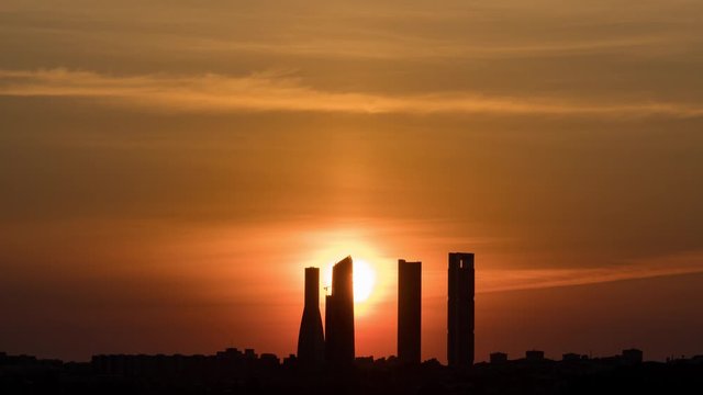 Night to day Time Lapse of a sunrise in Madrid 4 Towers. Skyline silhouette in 4K.
