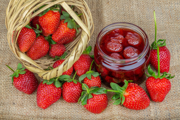 Naturel strawberries jam in a glass jar and fresh strawberriess 