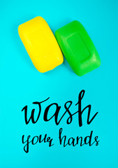 Wash your hands. Soap bar on blue background with motivational quote. Health care and hygiene.	