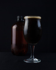 This bowl is made of crystal. The beer is a Dry Stout with grape must Tannat, Cabernet Franc, and Petit Verdot. Photo produced in low light, black background, lower exposure.