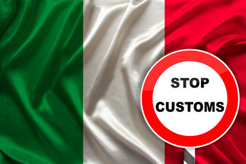 customs sign, stop, attention on the background of the silk national flag of Italy, the concept of border and customs control, violation of the state border, tourism restrictions
