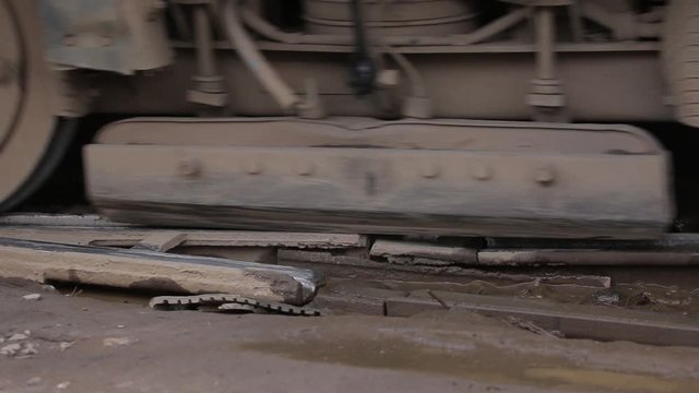 Poor condition of the road surface with tramway rails. Tram crossing dangerous road with rough broken rails. Sparks between parts. Intersection before reconstruction
