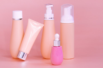 blank bottle packaging with natural cosmetic cream, serum, skincare, lotion, tonic. bio organic product on peach color background. spa concept. Plastic bottle label design. Cosmetic design template.